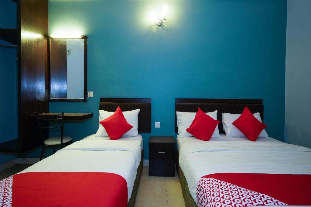 Postel nebo postele na pokoji v ubytování Hotel O Hotel Orchard Inn