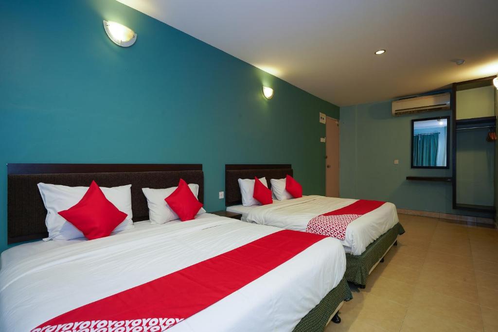 Postel nebo postele na pokoji v ubytování Hotel O Hotel Orchard Inn