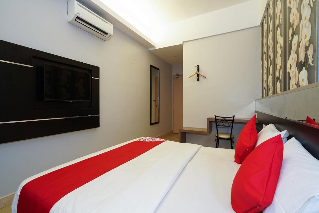 Postel nebo postele na pokoji v ubytování Hotel O Hotel Orchard Inn