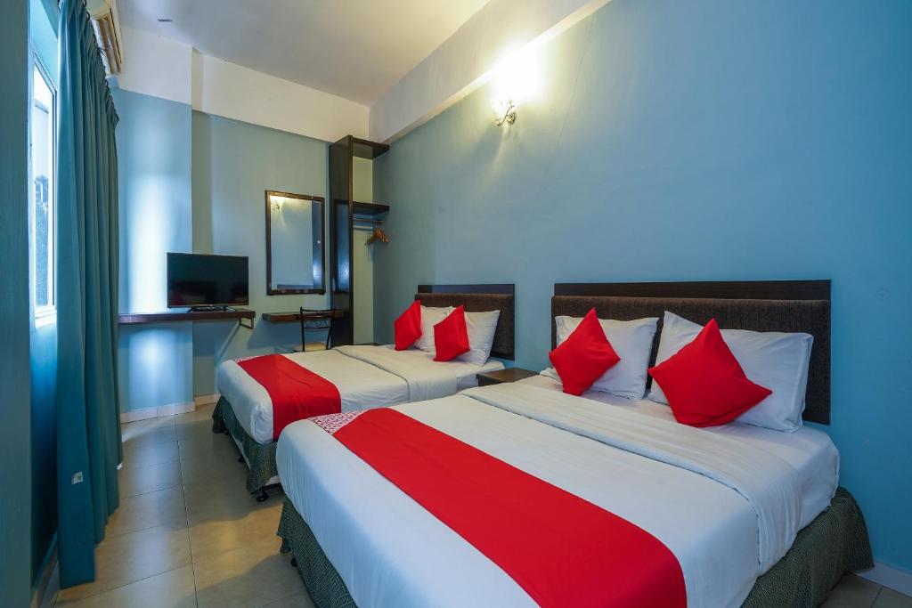 Postel nebo postele na pokoji v ubytování Hotel O Hotel Orchard Inn