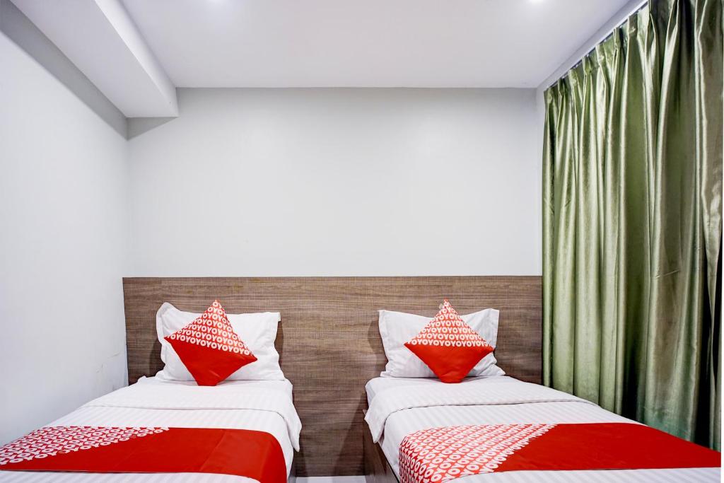 Postel nebo postele na pokoji v ubytování Collection O Gapura Hotel Near Parapat Penatapan Danau Toba