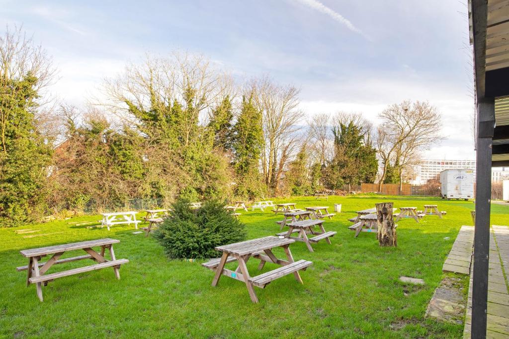 a group of picnic tables in a park at The Green Man Pub and Hotel by OYO in London