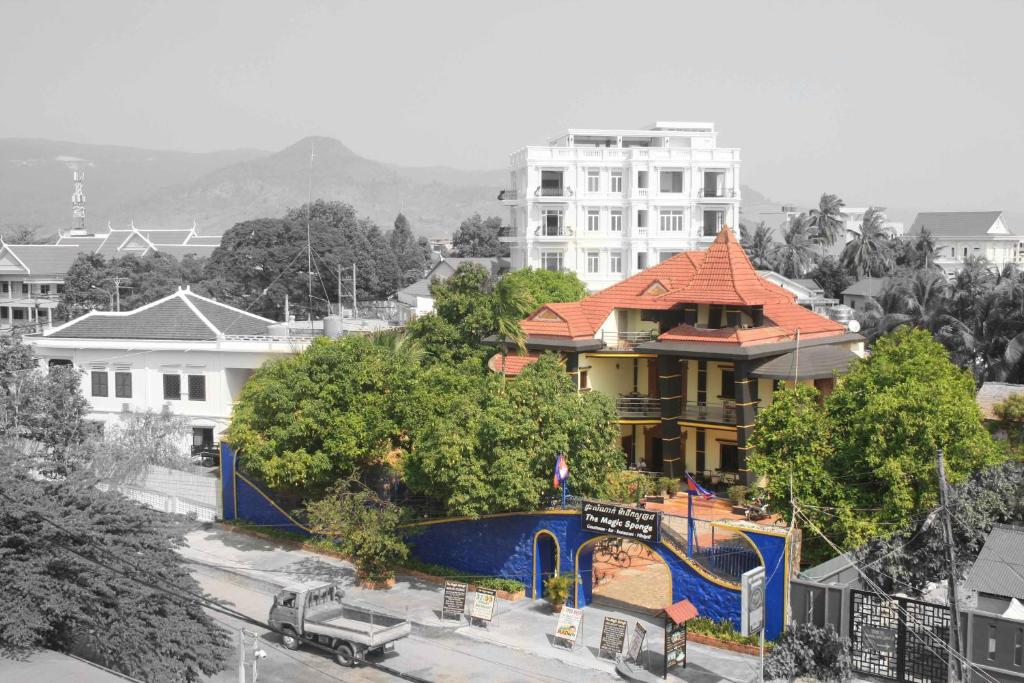 a building with an orange roof in a city at The Magic Sponge in Kampot