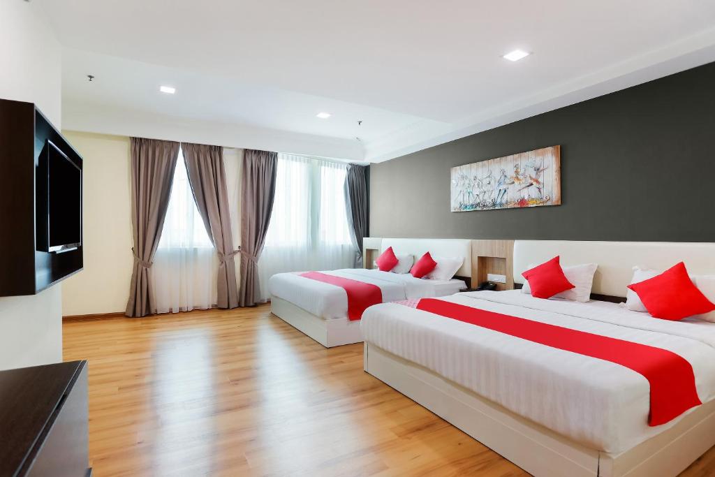 Postel nebo postele na pokoji v ubytování Collection O Hotel Super Cowboy