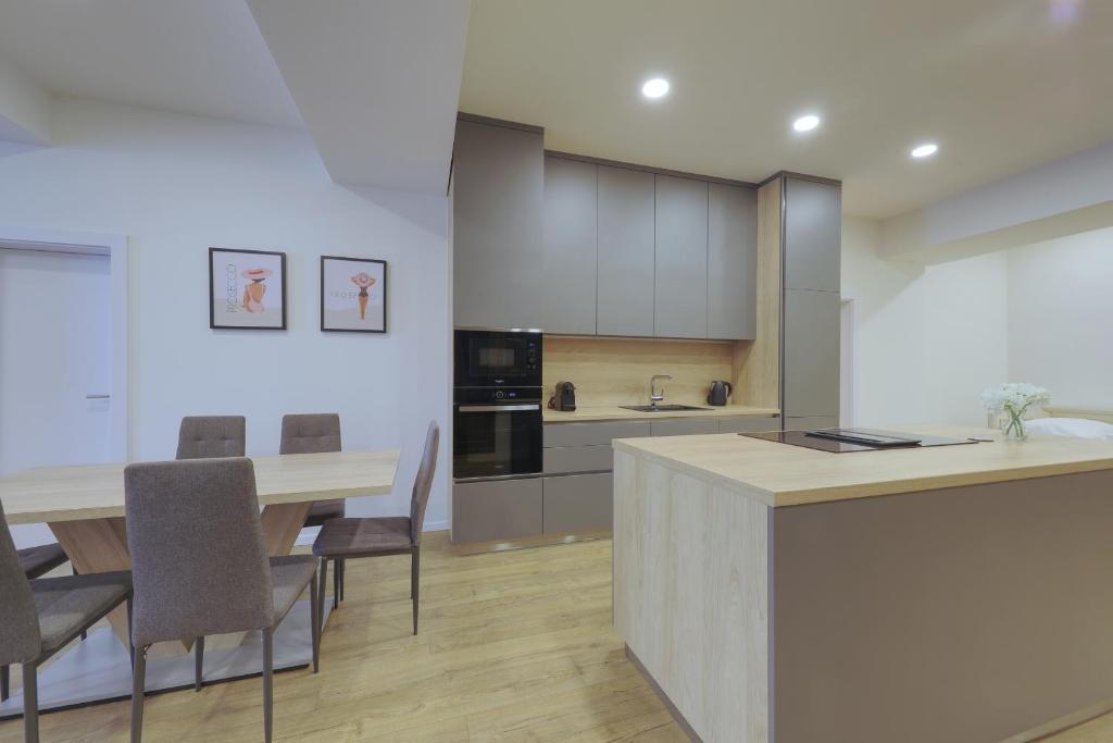 a kitchen and dining room with a table and chairs at Shone apartment old town 2 bedroom in Bratislava