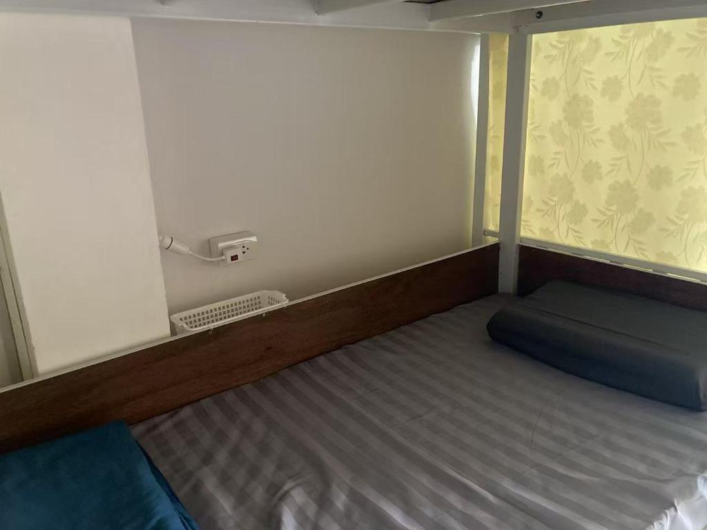 Postel nebo postele na pokoji v ubytování KingSun HOSTEL 金珊旅馆