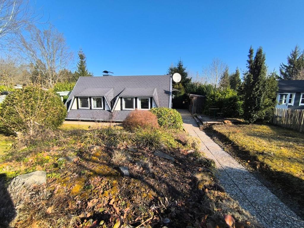 a house with a yard with a driveway at Eifel Residence in Gerolstein