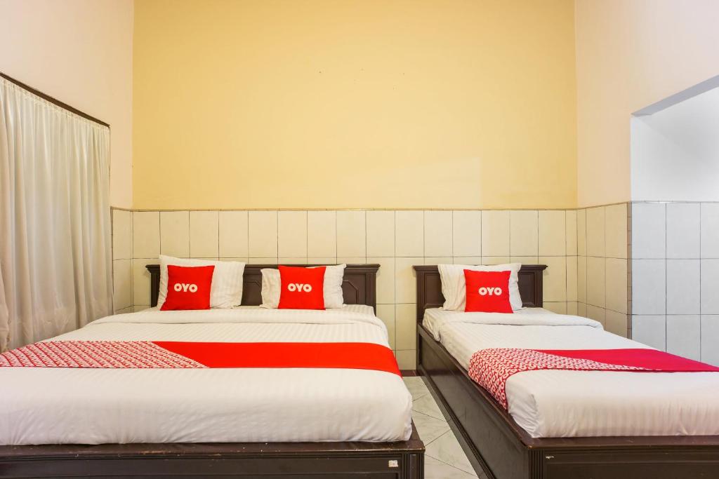 Postel nebo postele na pokoji v ubytování OYO 2180 Vina Vira Hotel