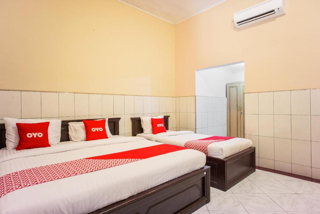 Postel nebo postele na pokoji v ubytování OYO 2180 Vina Vira Hotel