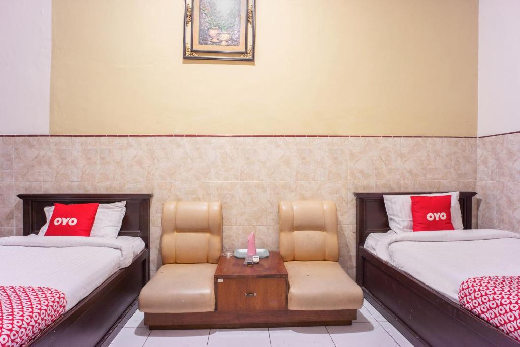Postel nebo postele na pokoji v ubytování OYO 2180 Vina Vira Hotel
