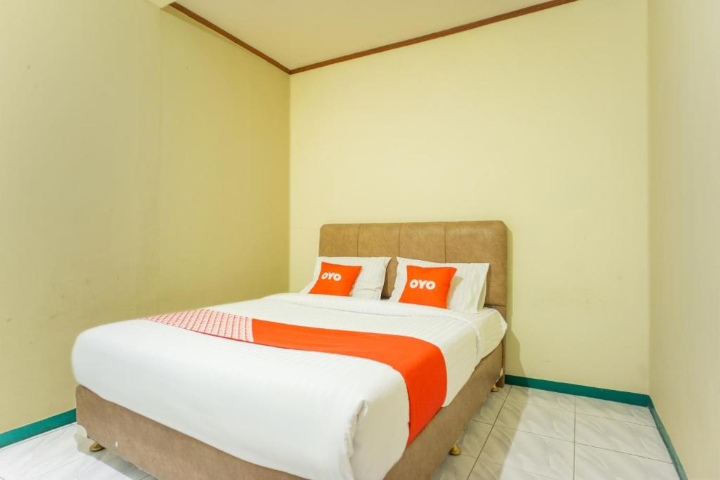 Postel nebo postele na pokoji v ubytování OYO 2180 Vina Vira Hotel