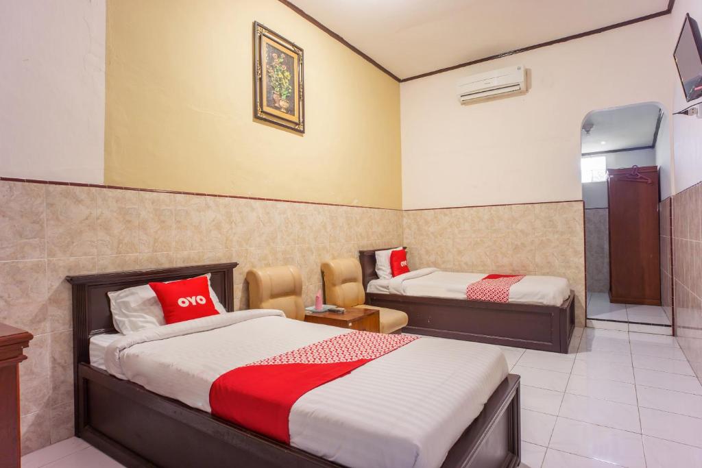 Postel nebo postele na pokoji v ubytování OYO 2180 Vina Vira Hotel