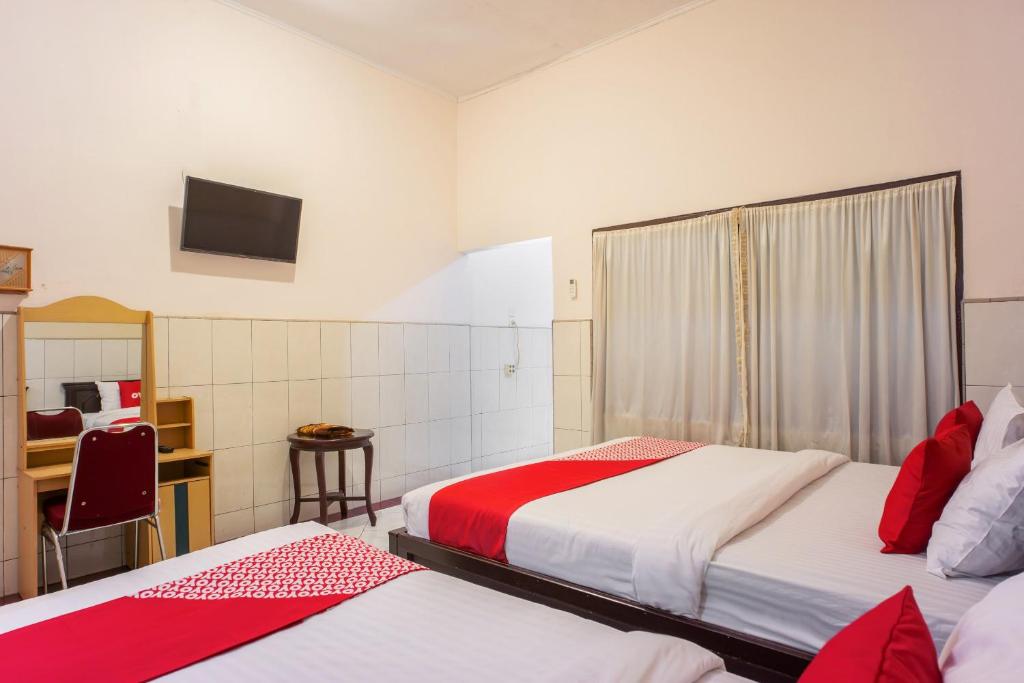Postel nebo postele na pokoji v ubytování OYO 2180 Vina Vira Hotel