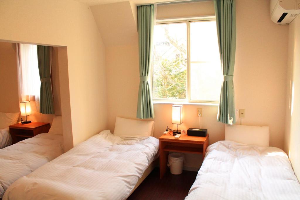 Postel nebo postele na pokoji v ubytování 彩の宿楓泉