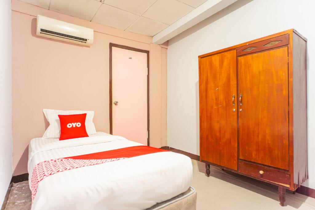 Postel nebo postele na pokoji v ubytování OYO 2180 Vina Vira Hotel
