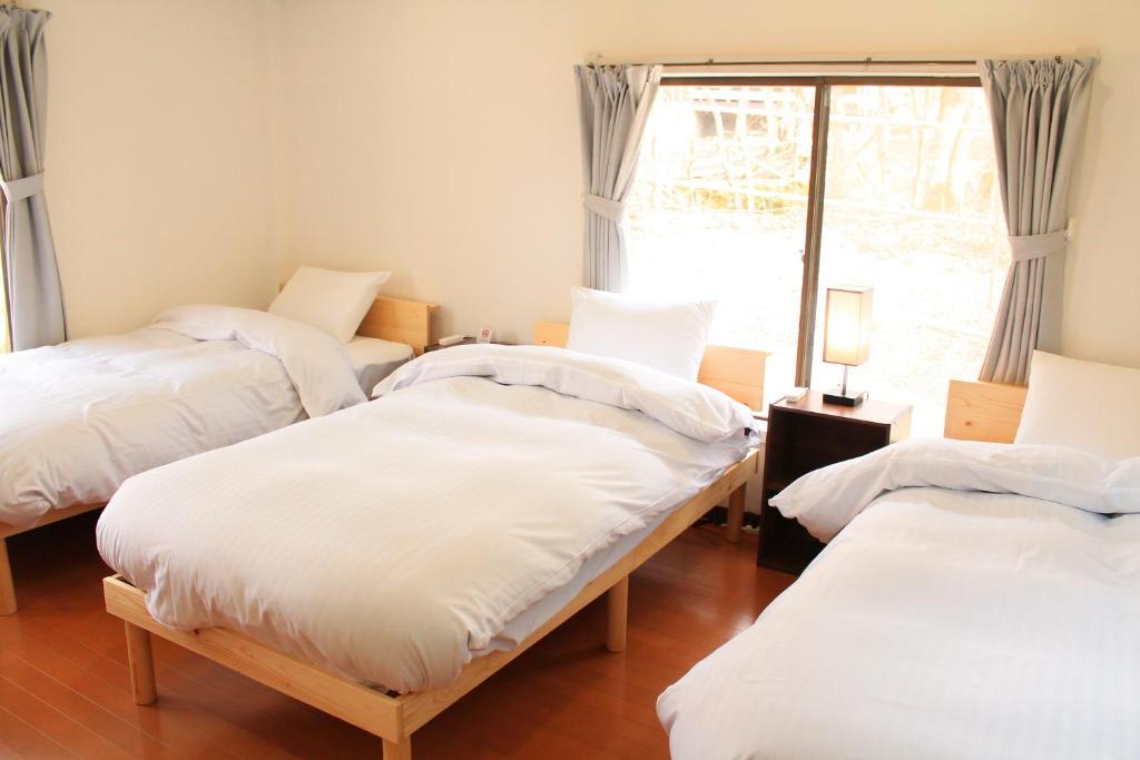 Postel nebo postele na pokoji v ubytování 彩の宿楓泉