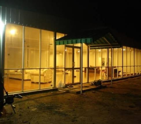 a building that is lit up at night at Kitty cointainer bungalow ambewela - kcb ambewela in Nuwara Eliya