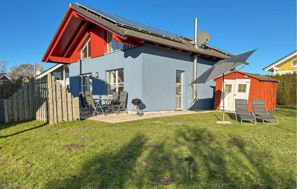 a house with a table and chairs in a yard at Seebrise in Süssau