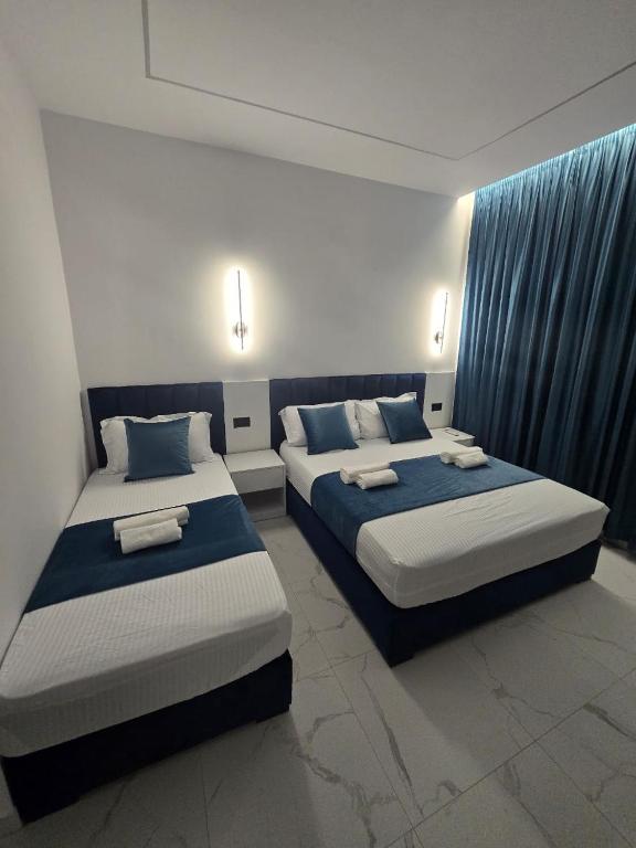 Postel nebo postele na pokoji v ubytování Elite Inn