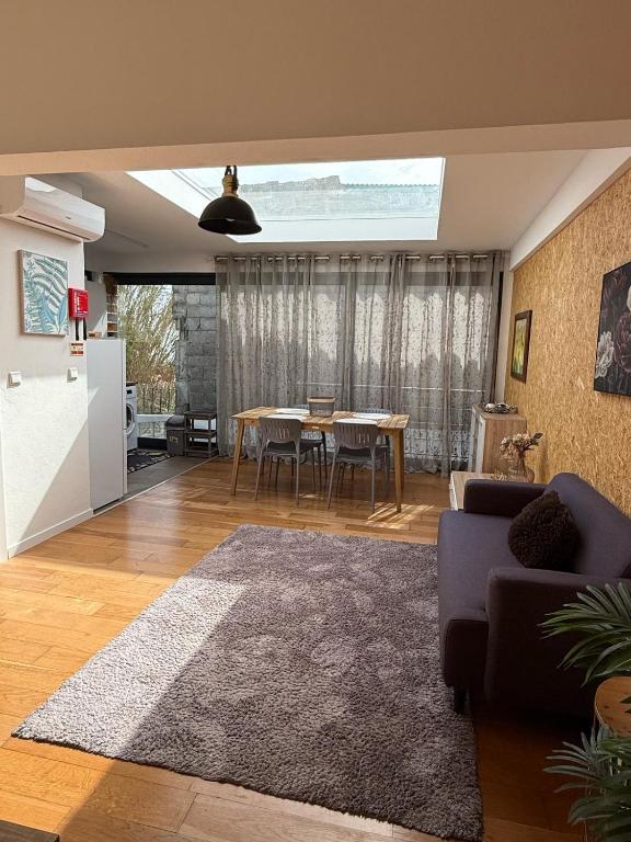 a living room with a couch and a table at Apartamento Deluxe II RB in Ribeira Brava