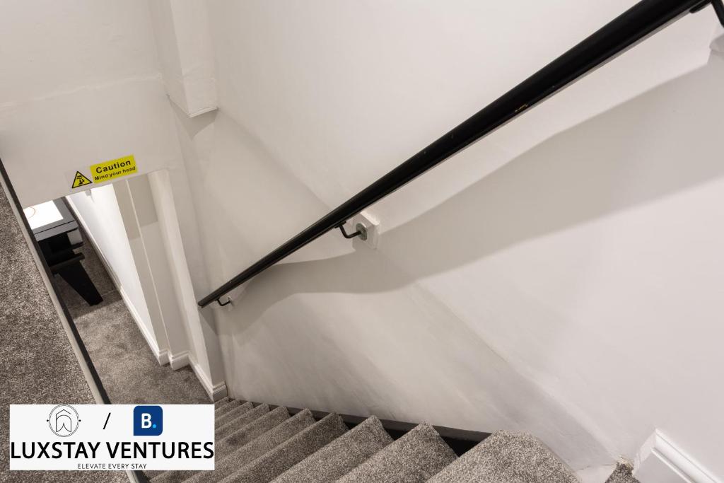 a staircase in a building with a stair railing at Bright and Spacious 2BR Maisonette Sleeps 8, Game Room, 5 mins to Brighton Beach and City Centre in Brighton & Hove