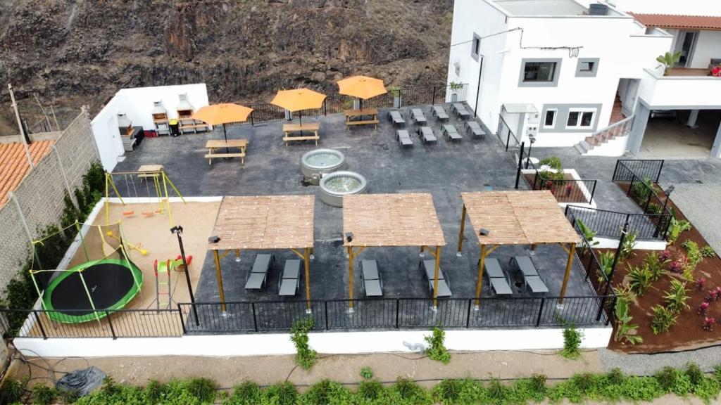 an aerial view of a patio with tables and umbrellas at Hacienda Adejo in Moya