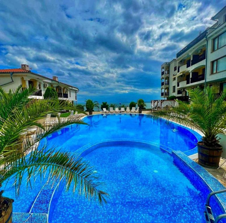 a large blue swimming pool next to some buildings at К-с Сън Коуст in Sveti Vlas