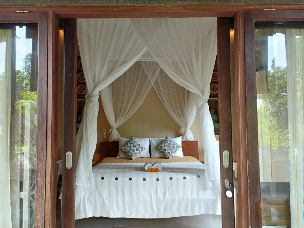 Postel nebo postele na pokoji v ubytování Umah Ubud Guest House