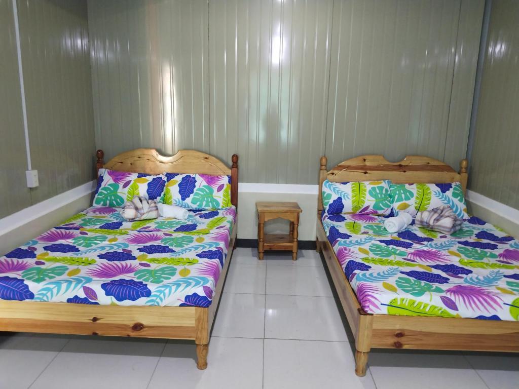 two beds sitting next to each other in a room at Ahava Lodge in Cervantes