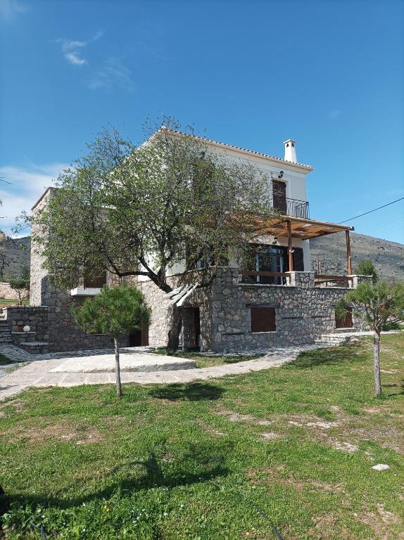 a stone house with a tree in front of it at Villa Rodi in Galaxidi