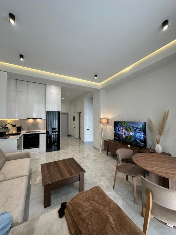 a living room with a couch and a table at Sea Breeze Polo Residence in Baku