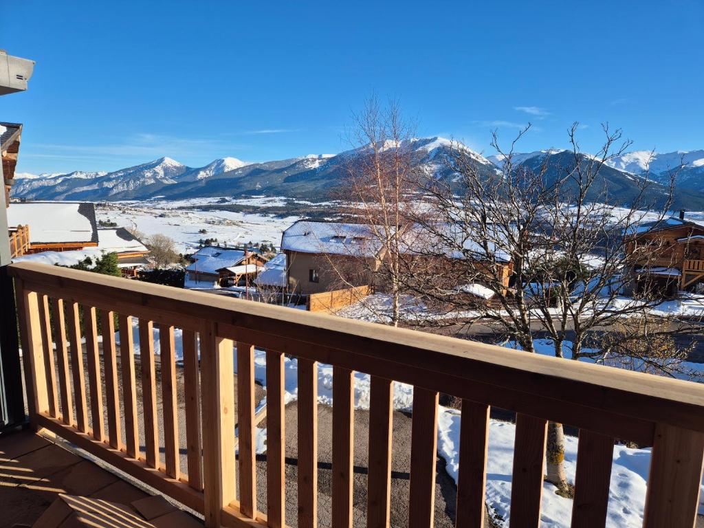 a balcony with a view of the snow covered mountains at 'Le Bellevue' coté Montagne BY P&T in Font-Romeu