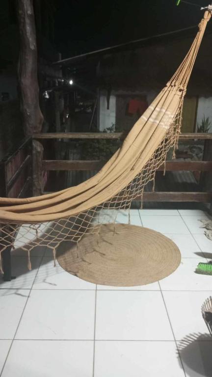 a hammock on the floor of a room at La Casa del Monica in Itacaré