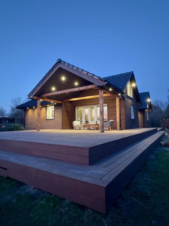 a house with a large deck in front of it at Luxury Nature Retreat in Gilleleje