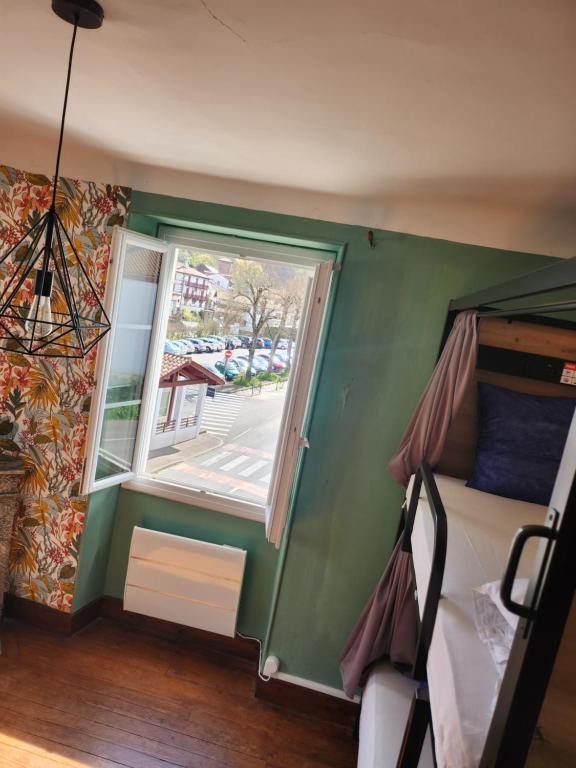 a small room with a bed and a window at Gite Compostella in Saint-Jean-Pied-de-Port