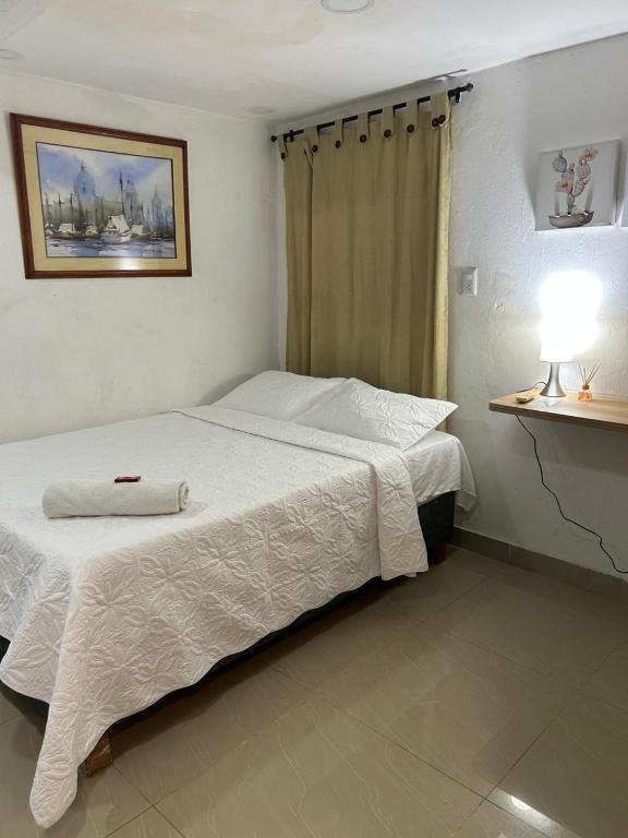 Postel nebo postele na pokoji v ubytování Hostal Casa de las Americas