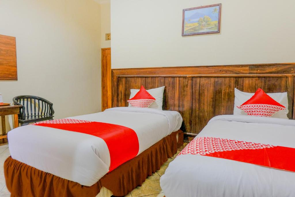 Postel nebo postele na pokoji v ubytování OYO 2643 Hotel Graha Prima