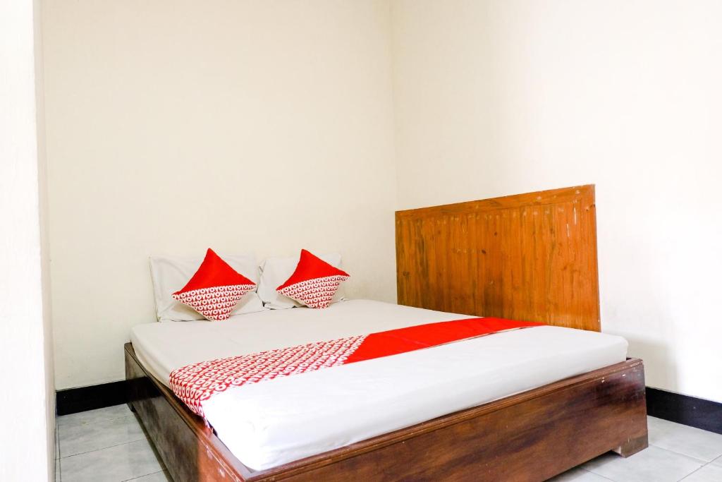 Postel nebo postele na pokoji v ubytování OYO 2643 Hotel Graha Prima