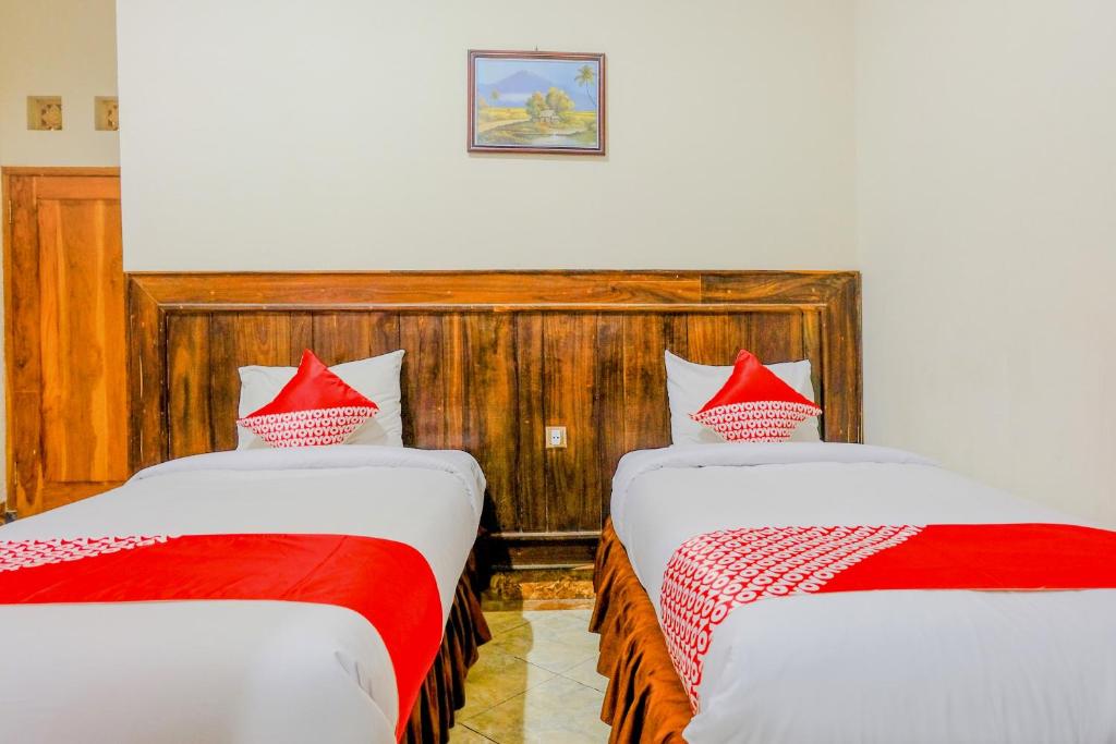 Postel nebo postele na pokoji v ubytování OYO 2643 Hotel Graha Prima