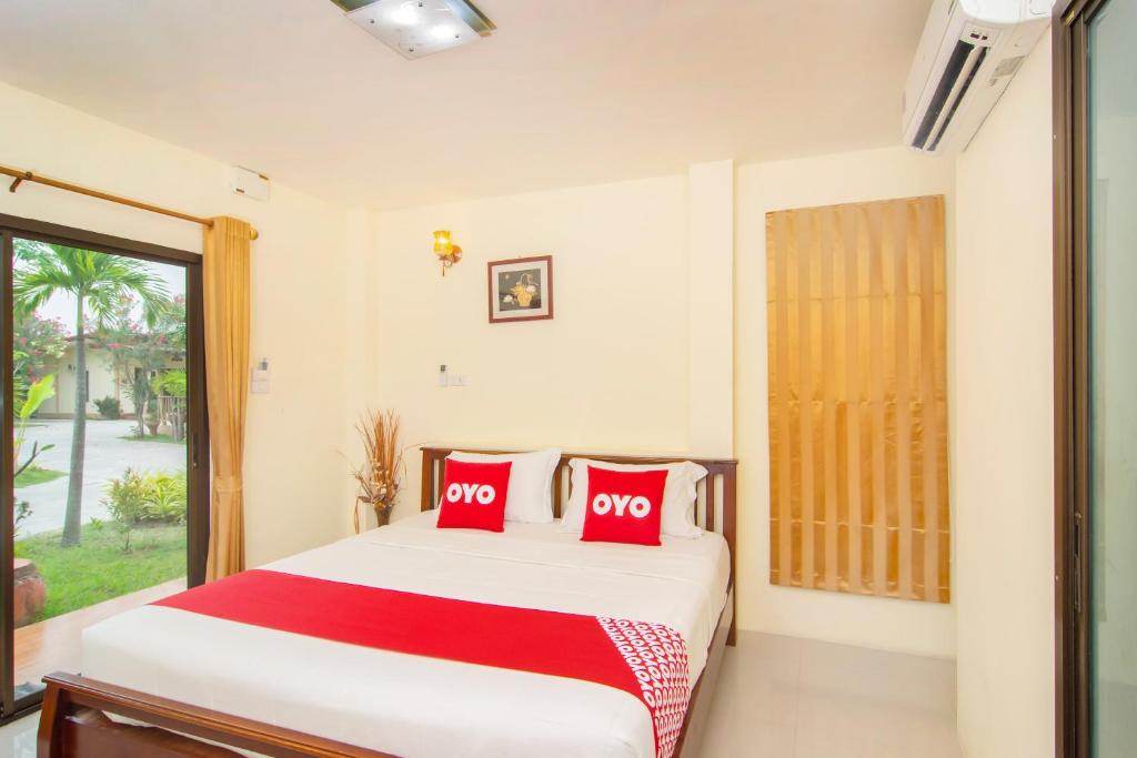 Postel nebo postele na pokoji v ubytování OYO 607 Nawang Resort