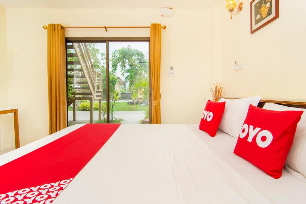 Postel nebo postele na pokoji v ubytování OYO 607 Nawang Resort