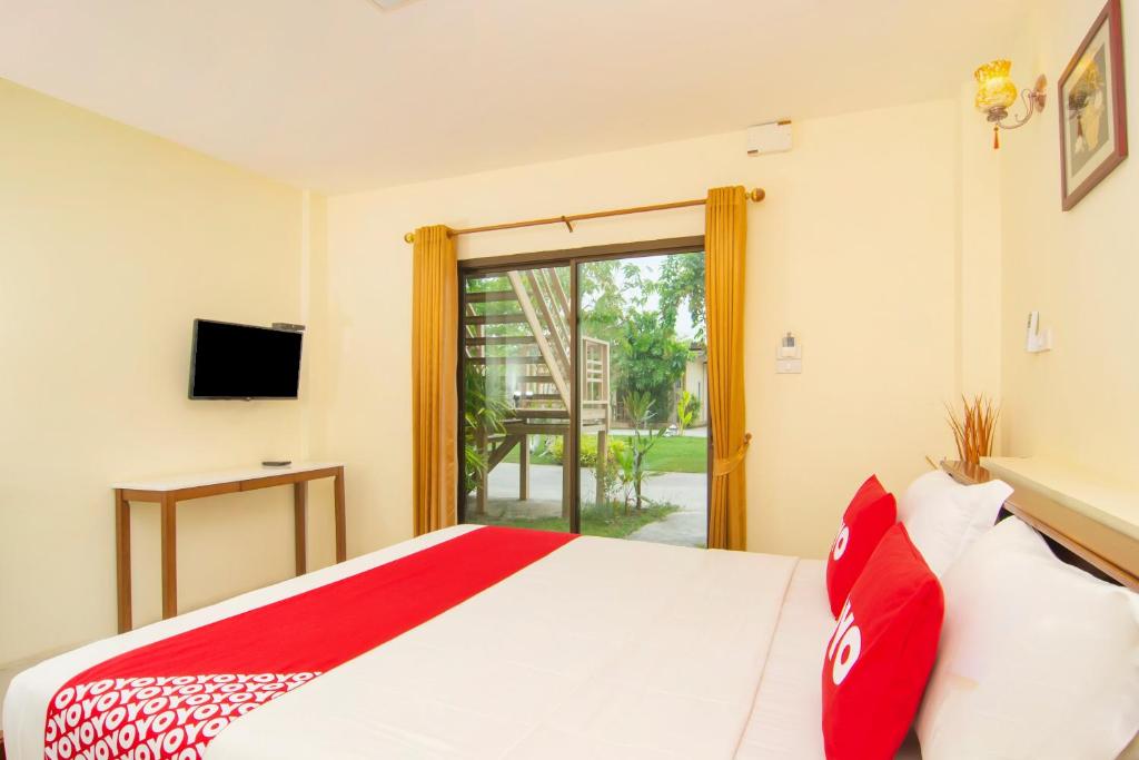 Postel nebo postele na pokoji v ubytování OYO 607 Nawang Resort