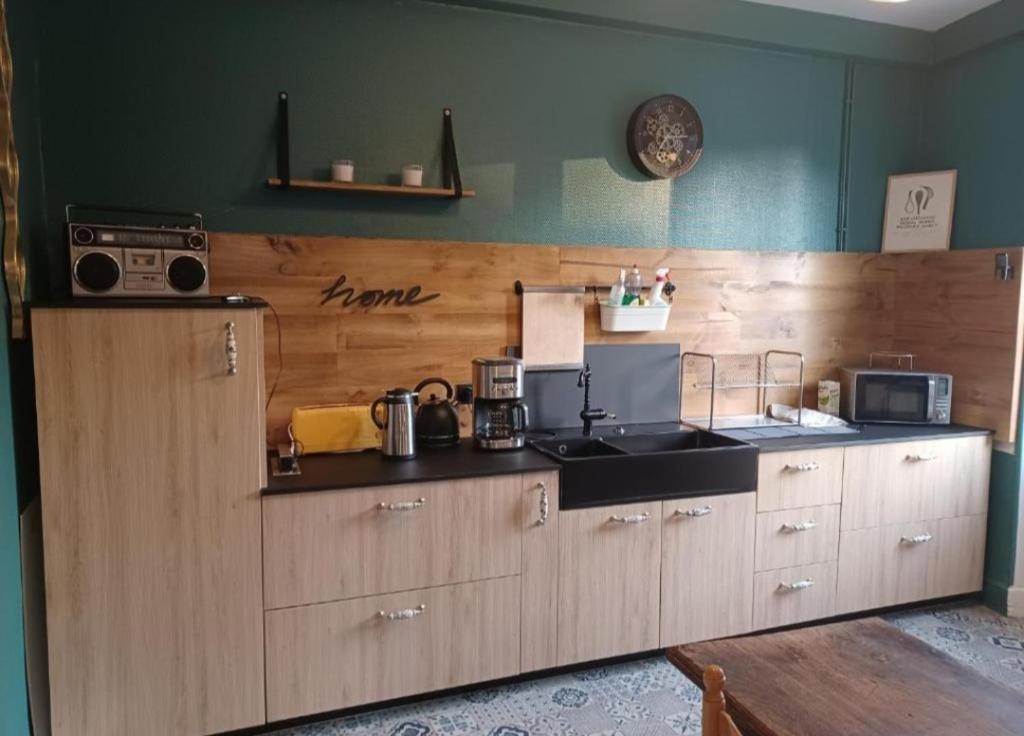 a kitchen with wooden cabinets and a counter top at Gite Compostella in Saint-Jean-Pied-de-Port