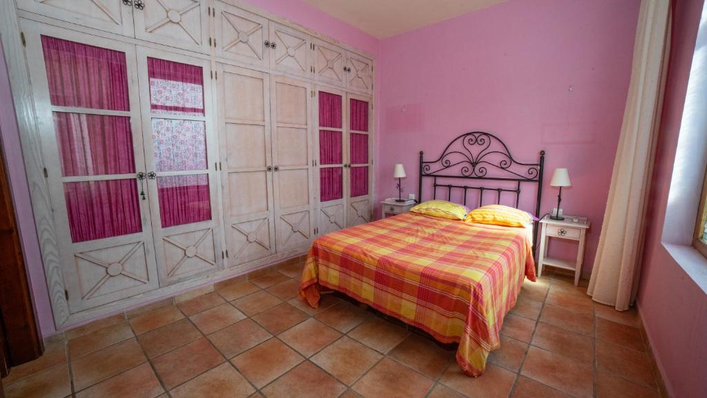 A bed or beds in a room at VILLA CANTARES