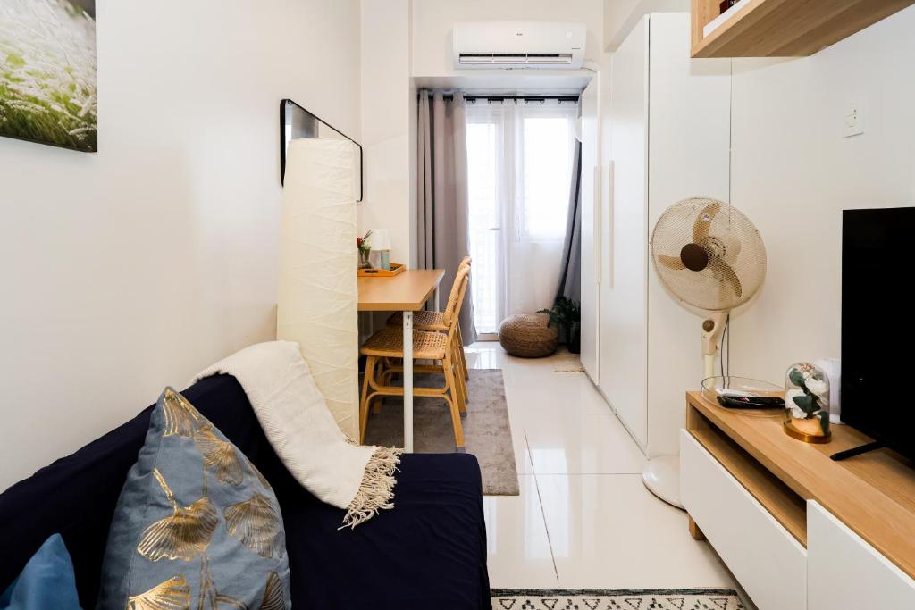 a living room with a couch and a table at Charlie's Staycation at Coast Residences in Manila