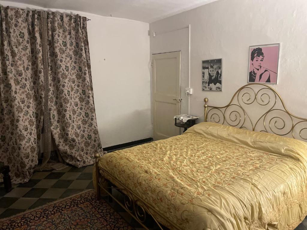 a bedroom with a bed with a gold bedspread at Cascina Valgrande, Monferrato in Carpeneto