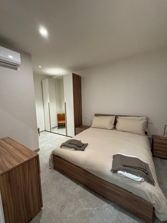 a bedroom with a large bed and a mirror at Casa Lucia in Strada