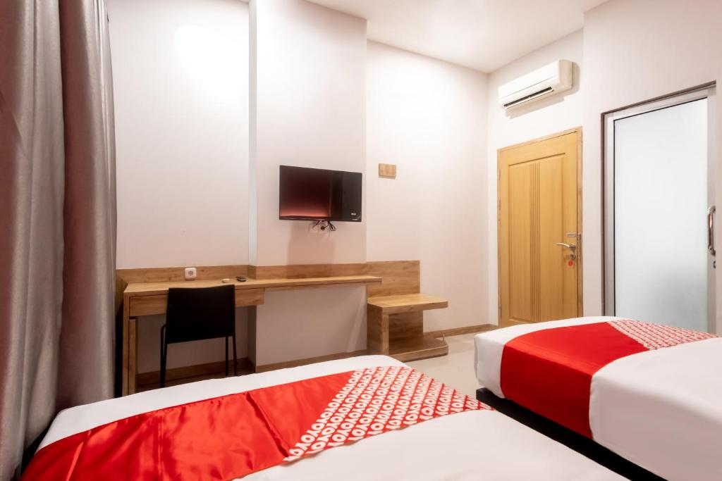 Postel nebo postele na pokoji v ubytování OYO 3159 Festive Inn