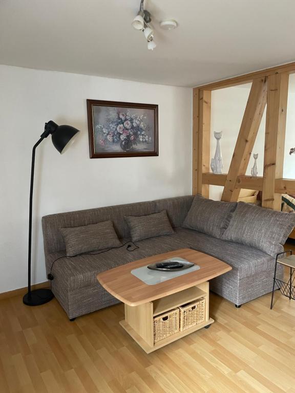 a living room with a couch and a table at Ferienwohnung Carmen in Krakow am See