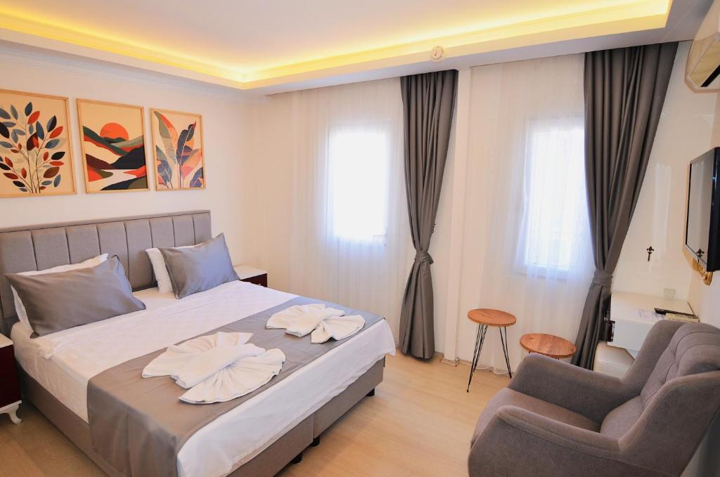 Postel nebo postele na pokoji v ubytování Royalis Apart Hotel